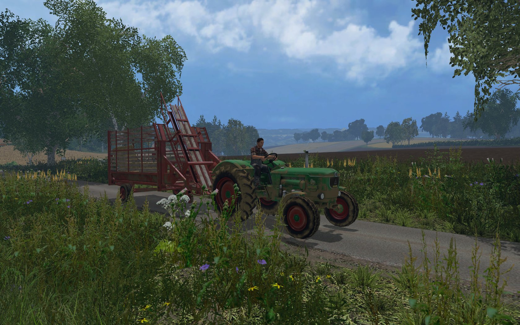 Deutz mit Ballensammelwagen
