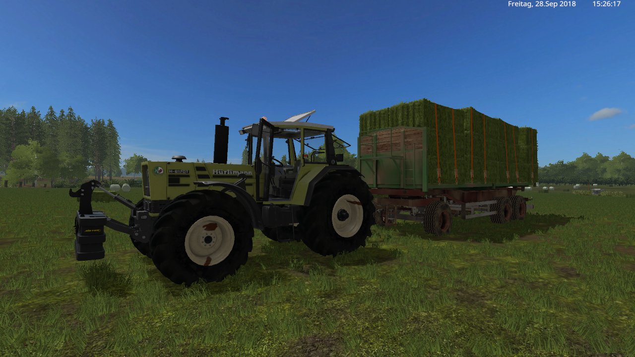 mit den hürlimann h 6170t und ballen wagen die gras ballen von feld holen