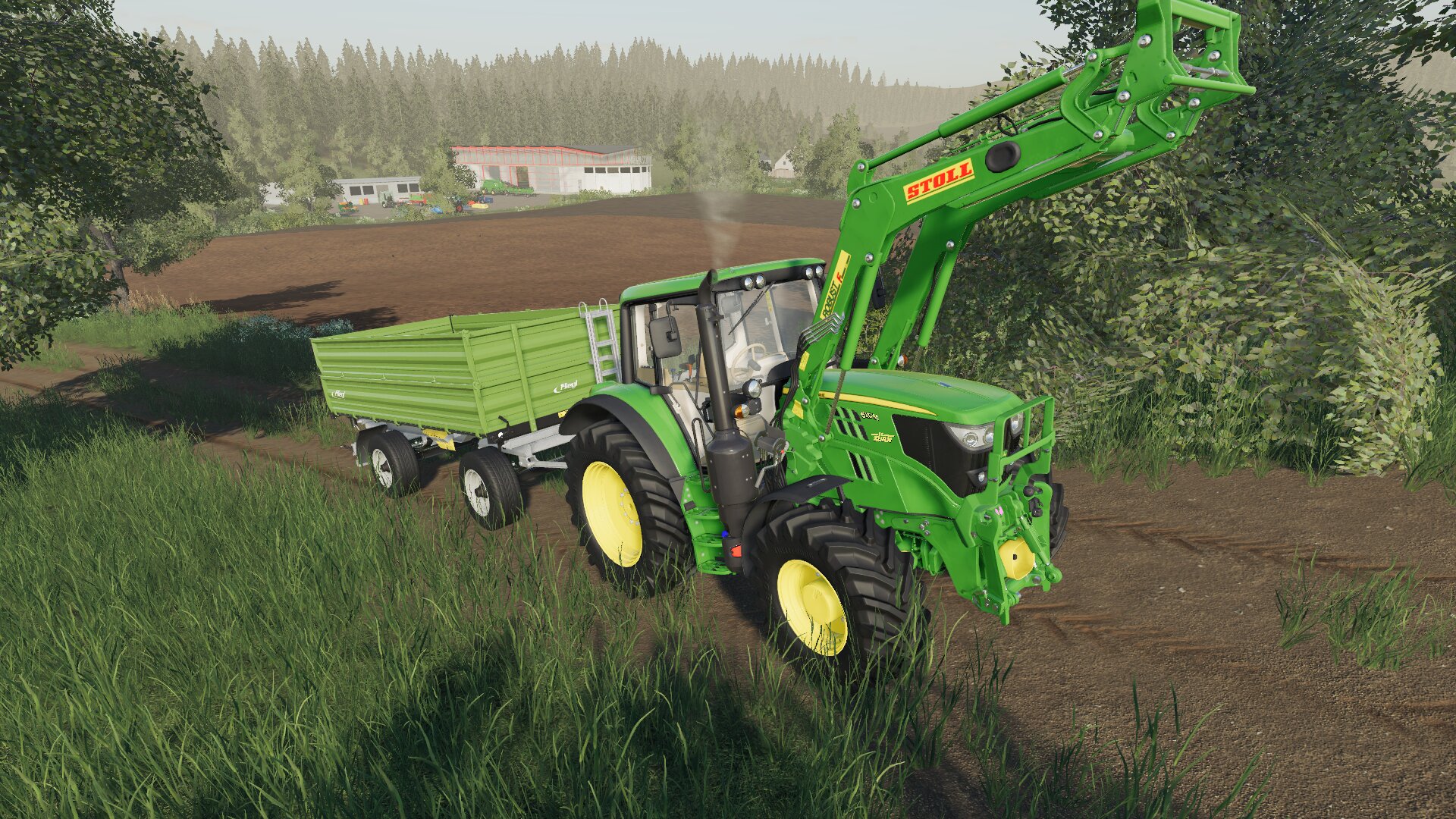 John Deere 6M mit Fliegl Anhänger und Stoll